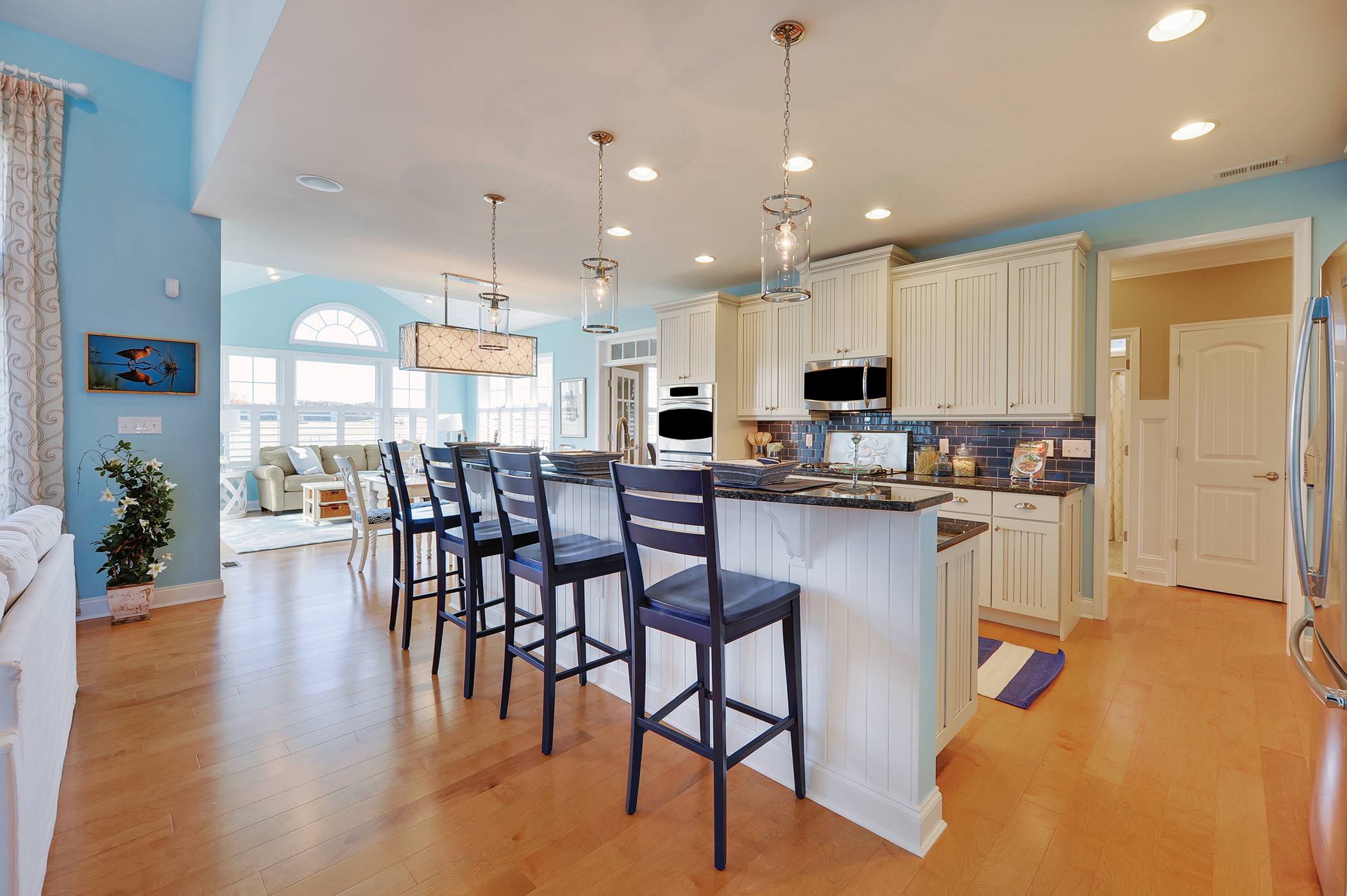 The combination of the bead board panel from the cabinets and wall paint color gives this casual kitchen a coastal feel. This casual design makes for a comfortable environment. 