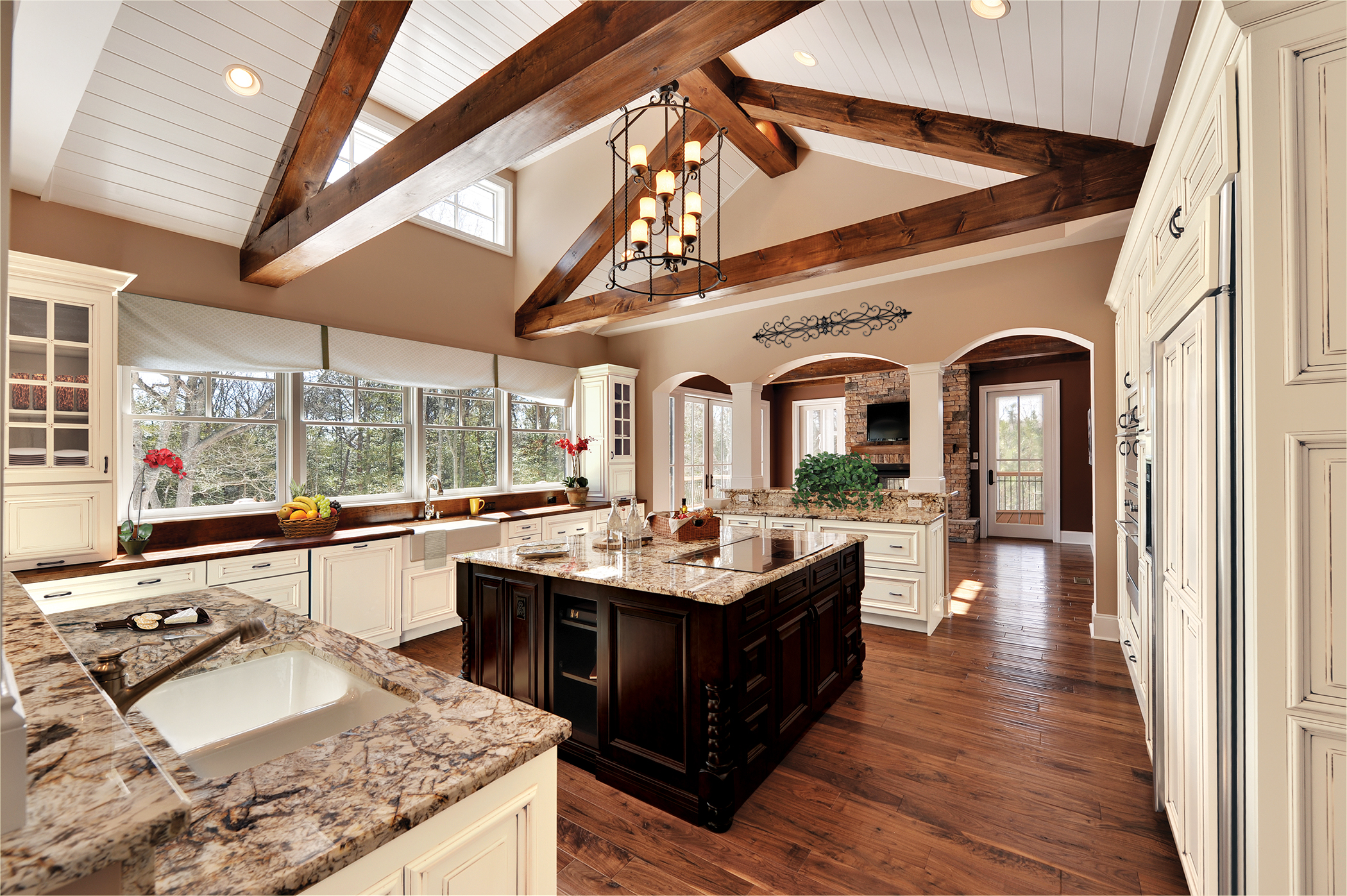 The architectural and top to bottom details are crucial to the design of this kitchen. From the beams and archways to the mullion cabinet doors and island legs, this kitchen portrays every aspect of traditional.
