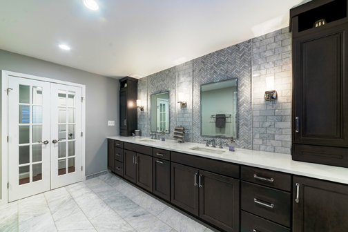 spa bathroom with dark cabinets and white countertops
