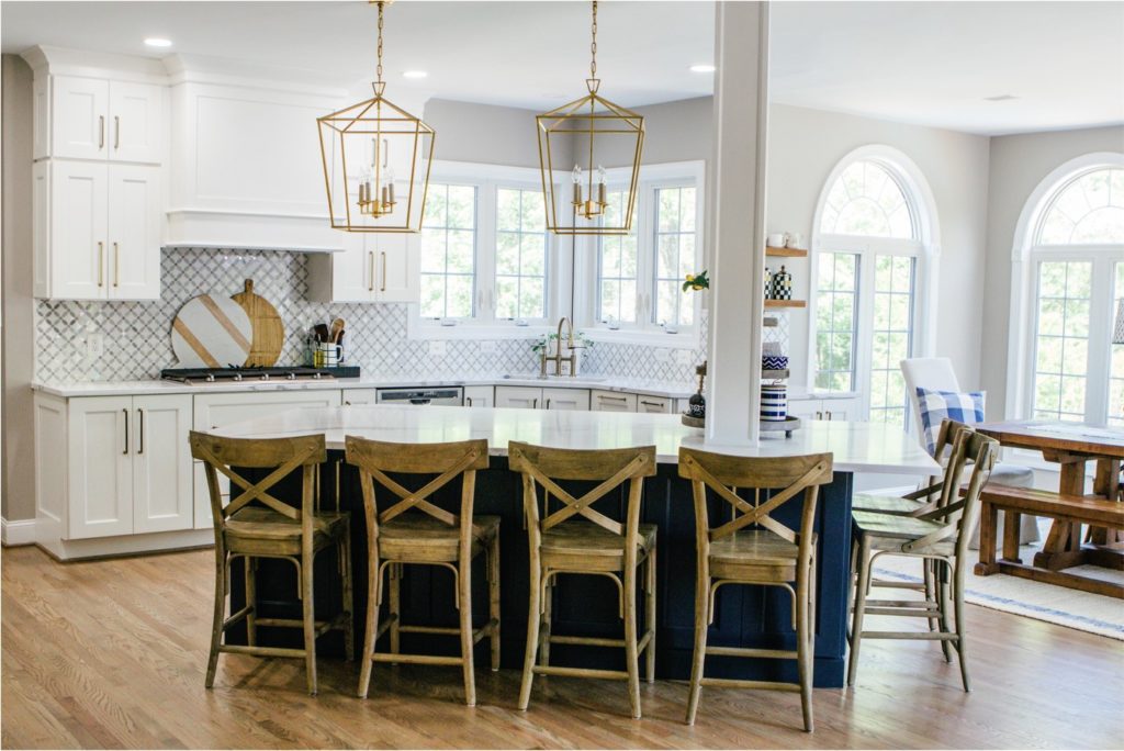 large kitchen with white cabinets and blue island