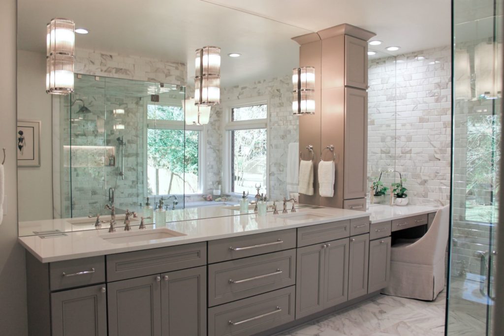 bathroom with light gray cabinets and seat