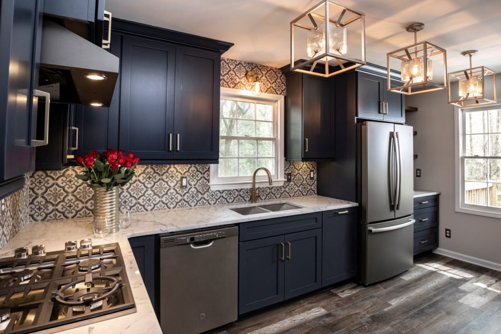 small kitchen with gray-blue cabinets and stainless steel appliances