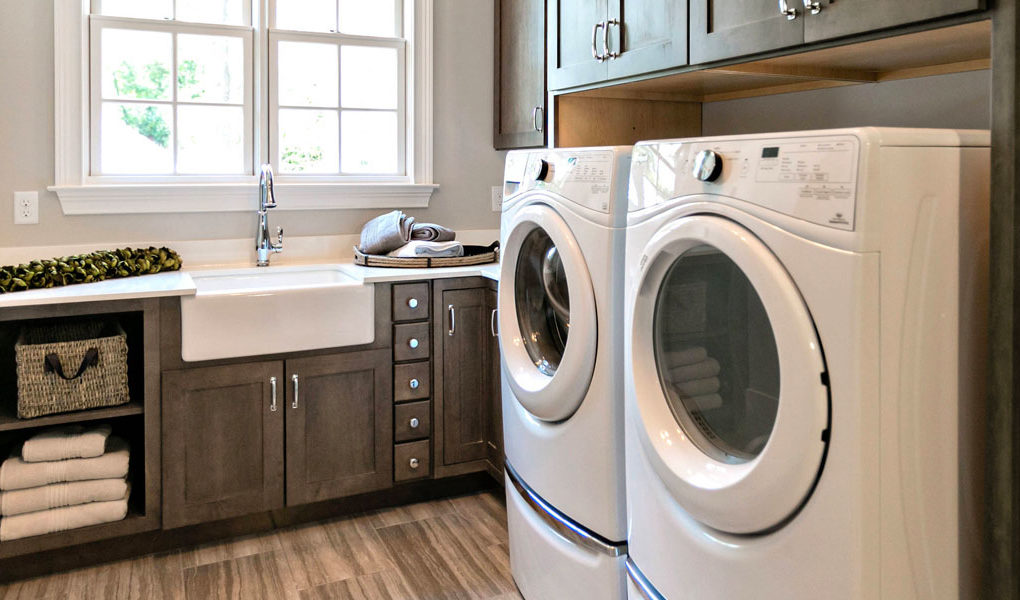 white washer and dryer side by side in laundry room